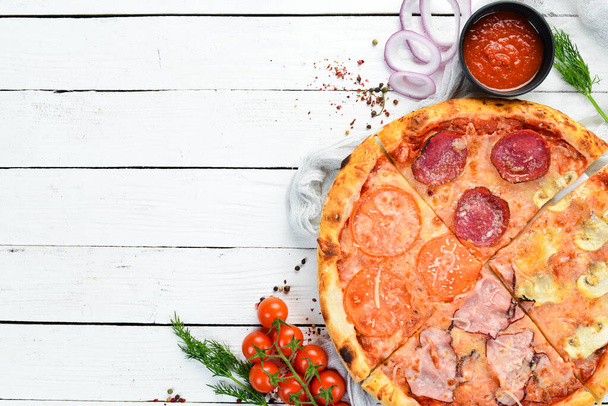 Homemade pizza with bacon, salami and tomatoes. Top view. - Фото, изображение