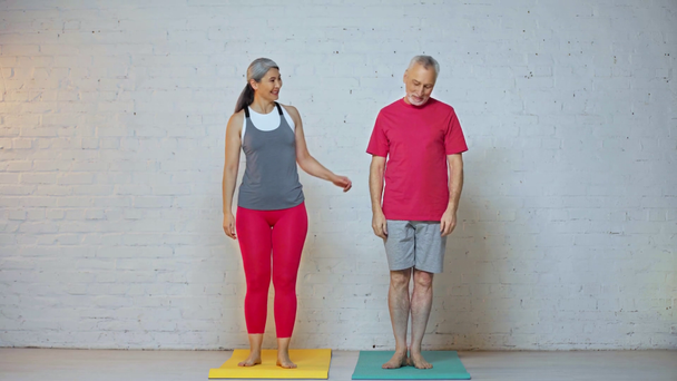 senior and interracial couple practicing yoga  - Footage, Video