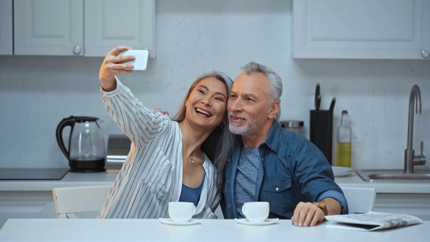 happy senior and interracial couple taking selfie  - Πλάνα, βίντεο