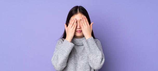 Young asian woman over isolated background covering eyes by hands - Фото, изображение