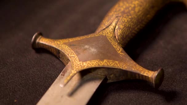 Közelkép a középkori fegyver nyeléről. Készletfelvétel. Szláv vagy keleti emberek ősi fegyverei a múzeumban, elszigetelt háttérrel - Felvétel, videó