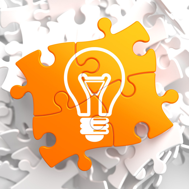 Light Bulb Icon on Orange Puzzle. - Photo, Image