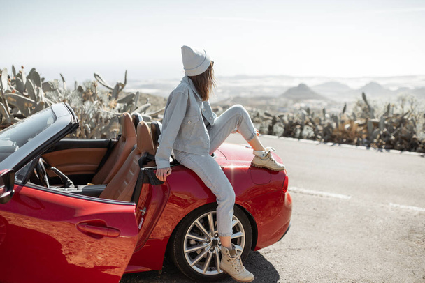Woman traveling by sports car on the island - Photo, Image