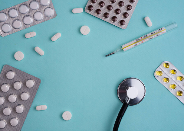 medical pills, stethoscope and a glass of water. Medicine concept - 写真・画像