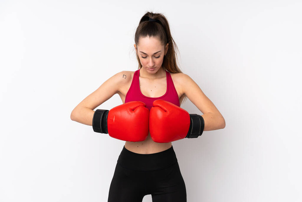 Young sport brunette woman over isolated white background with boxing gloves - Photo, Image