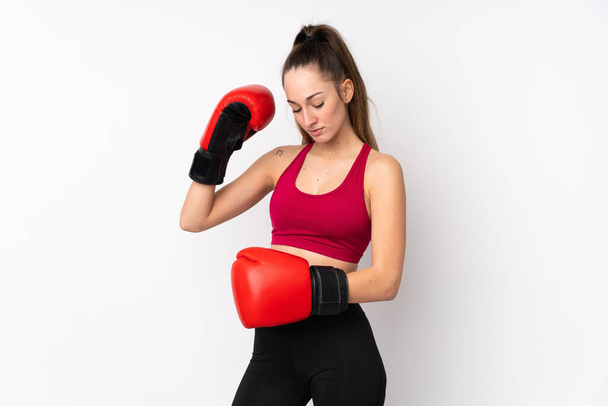 Young sport brunette woman over isolated white background with boxing gloves - Photo, image