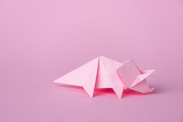 small origami rhinoceros on pink with copy space  - Fotoğraf, Görsel