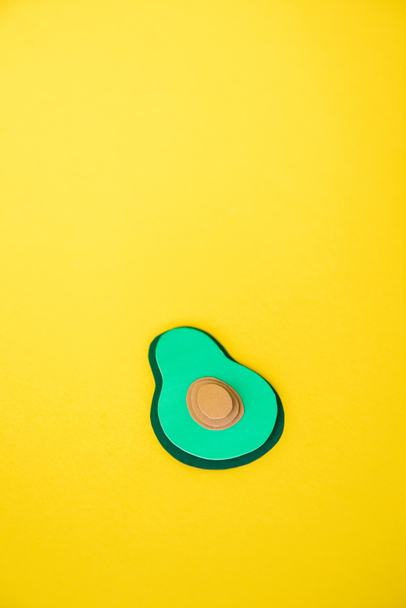 green and decorative paper avocado isolated on yellow  - Foto, Imagem