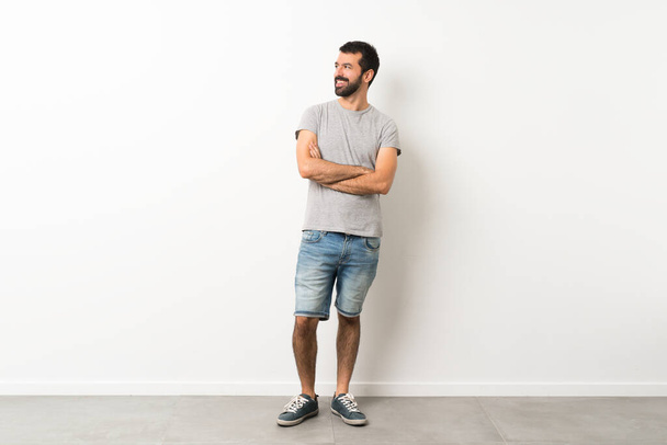 A full-length shot of handsome man with beard happy and smiling - Fotoğraf, Görsel