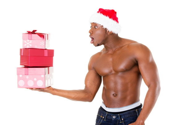 Attractive handsome nude man holding present in excitment. - 写真・画像