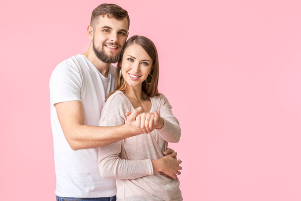 Happy engaged young couple on color background - Foto, Imagem
