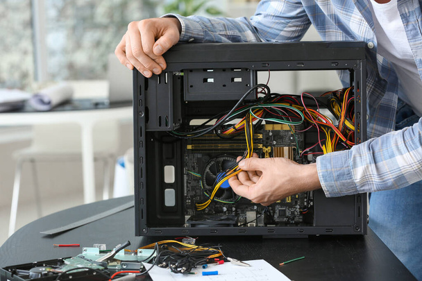 Electronic technician working in service center - Photo, image