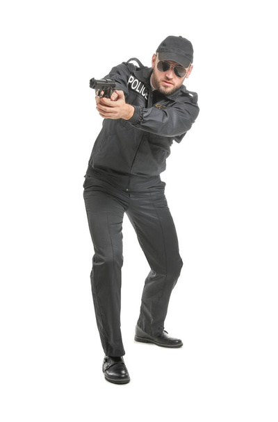 Male police officer with gun on white background - Photo, Image
