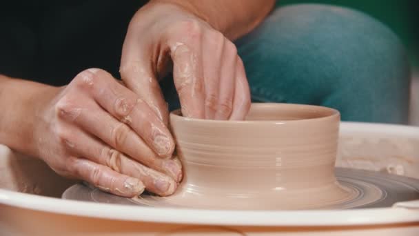Pottery - the master is raising the walls of the clay bowl with his hands on the potters wheel - Footage, Video