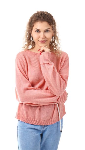 Beautiful young woman in warm sweater on white background - 写真・画像