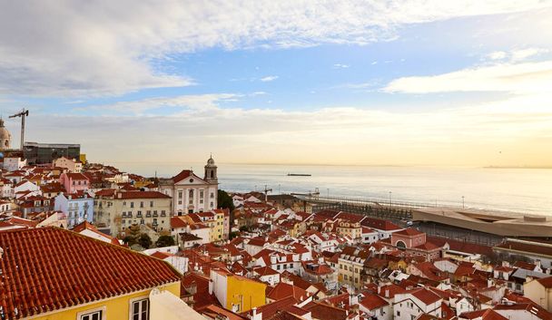 Lisbon, Portugal - Beautiful view from Miradouro de Santa Luzia on the red roofs and houses of old town - Fotó, kép