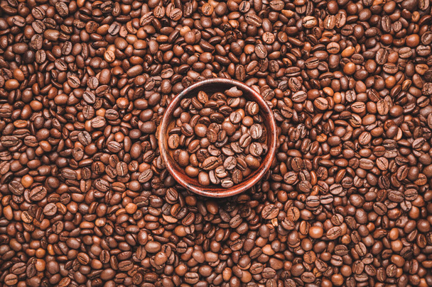 Bowl on roasted coffee beans - Photo, image