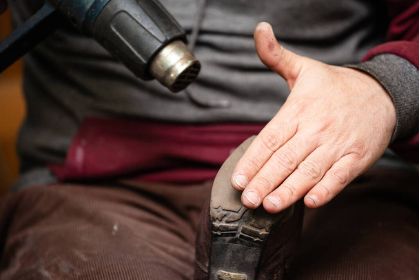 close up of the hands of a man repairing shoes - Photo, Image