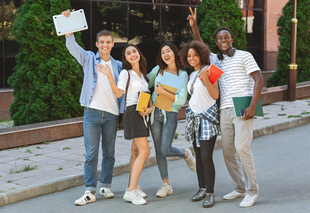 Portrait of happy university students posing outdoors after study or exam - Foto, imagen