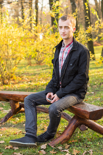 Young handsome man in autumn park - Fotó, kép
