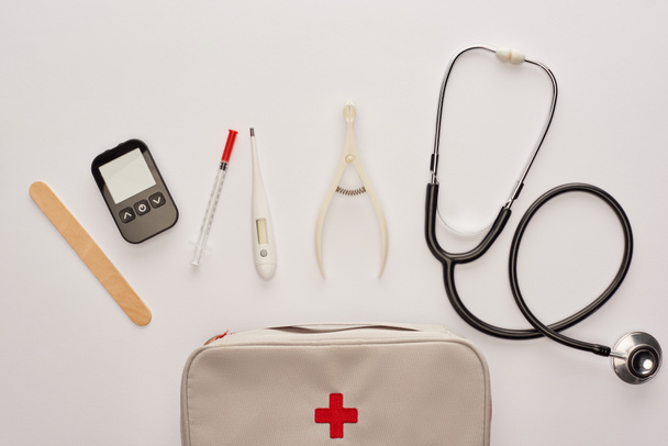 Top view of first aid kit with medical objects on white - Photo, Image