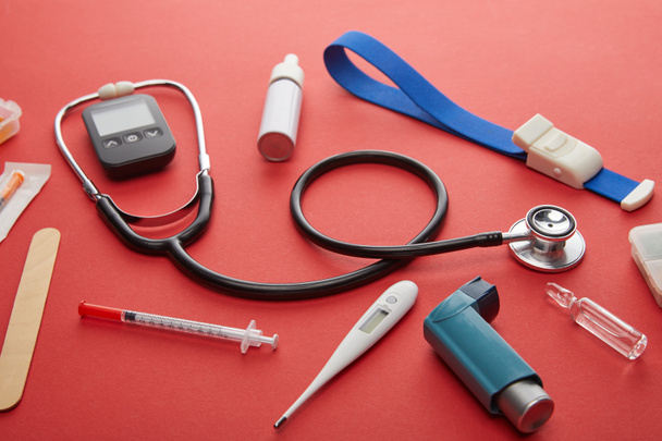 High Angle View of medical objects on red background - Photo, Image
