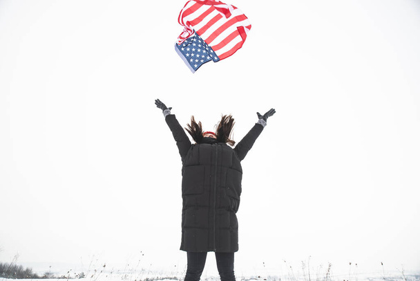 woman catch usa flag. winter time. patriotic concept - Photo, Image