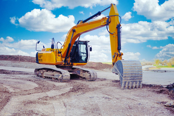 excavator at a street construction site on the countryside  - Photo, Image