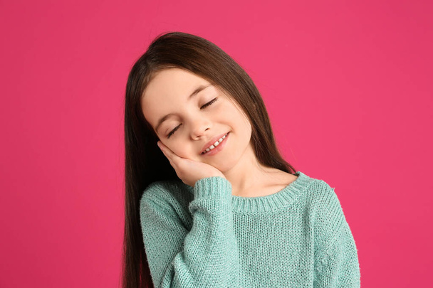Portrait of cute little girl on pink background - Foto, imagen