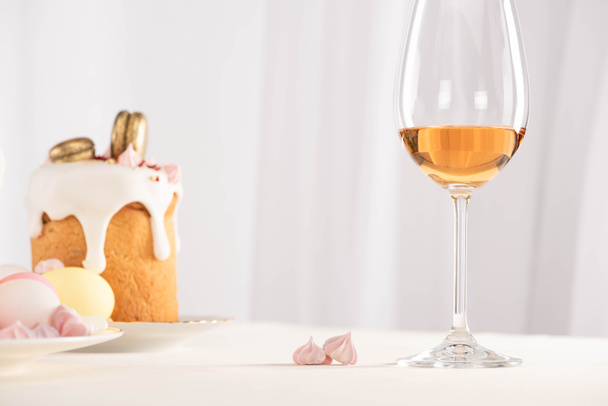 selective focus of Easter cake with eggs near wine glass and meringue - Photo, Image