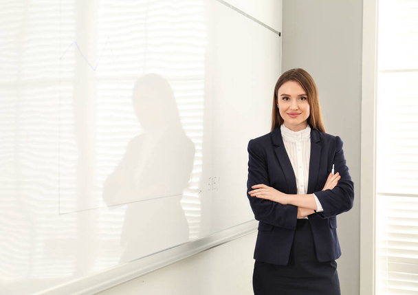 Professional business trainer near whiteboard in office - Fotó, kép