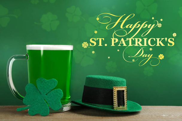 Green beer, hat and clover on wooden table. St. Patrick's Day celebration - Fotografie, Obrázek
