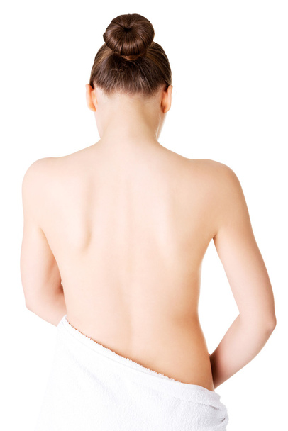 Attractive naked woman's back covered with towel. - Zdjęcie, obraz