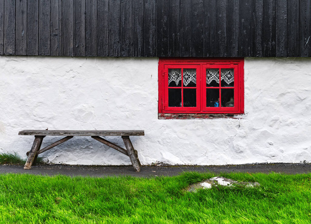 White house wall with red window on old faroese house - Photo, Image