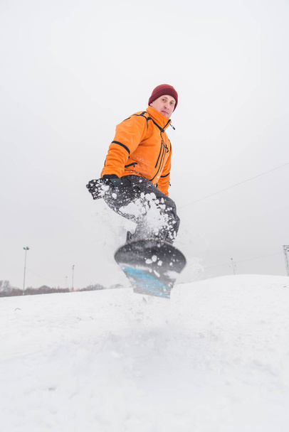 man snowboarding down by hill. winter sport time - 写真・画像