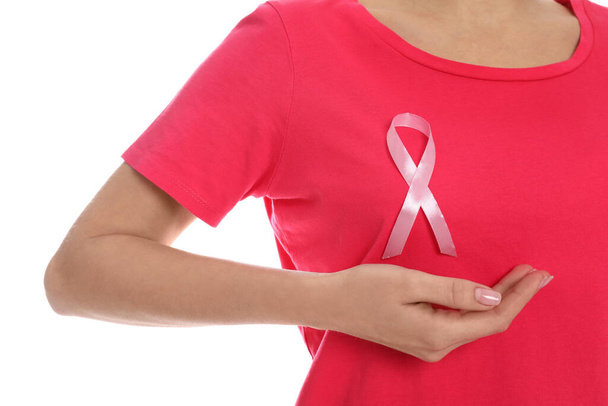 Woman with pink ribbon on white background, closeup. Breast cancer awareness - Fotografie, Obrázek