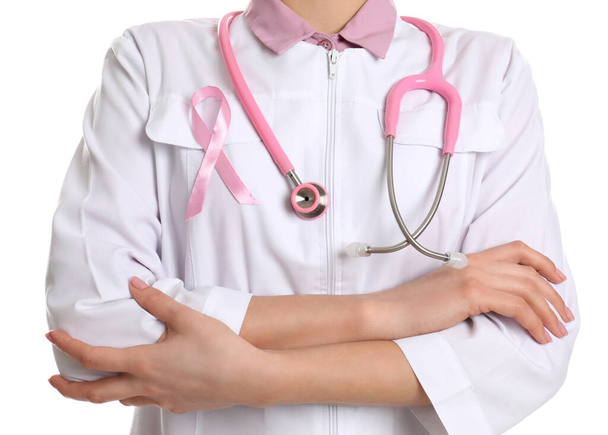 Doctor with pink ribbon and stethoscope on white background, closeup. Breast cancer awareness - Foto, Bild