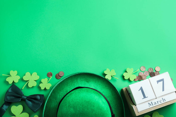 Flat lay composition with leprechaun hat on green background, space for text. St. Patrick's Day celebration - Фото, изображение