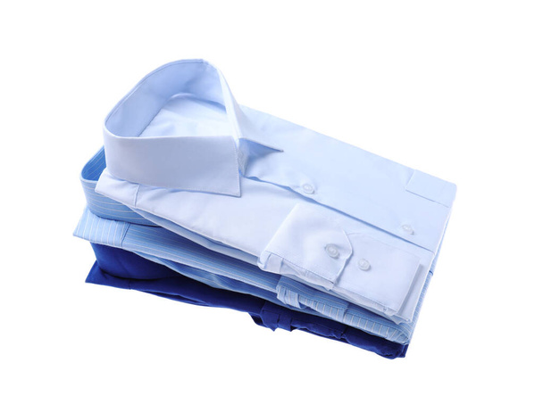 Stack of stylish shirts isolated on white. Dry-cleaning service - 写真・画像