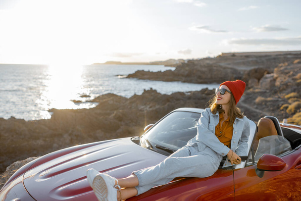 Woman traveling by car on the rocky coastline - Photo, Image