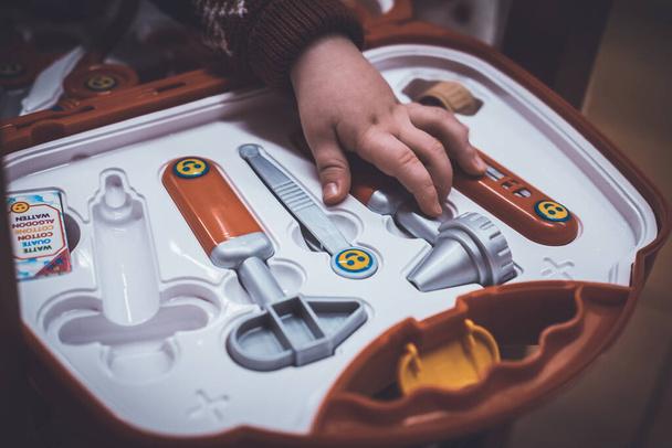Kids hands on a toy medical briefcase - Photo, Image