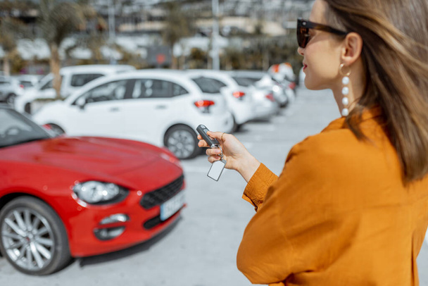 Woman with car keys at the parking - Foto, Bild