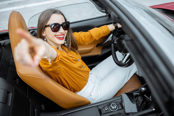 Happy woman driving a car - Фото, изображение