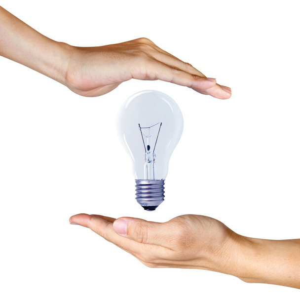 light bulb between two hands - Foto, Imagen