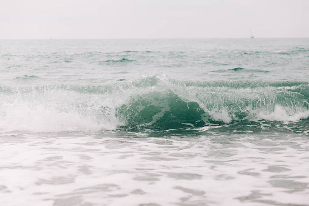 the sea wave arrives on the sandy shore . - Fotó, kép
