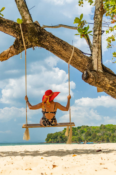 Beautiful Woman on a swing at the beach in Thailand - Fotoğraf, Görsel
