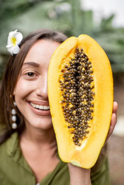 Portrait of a woman with papaya fruit - Zdjęcie, obraz