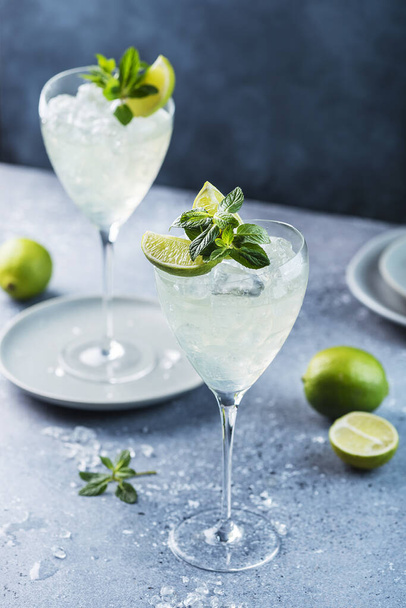 Summer cocktail mojito with rum, lime and mint, selective focus image - Фото, изображение