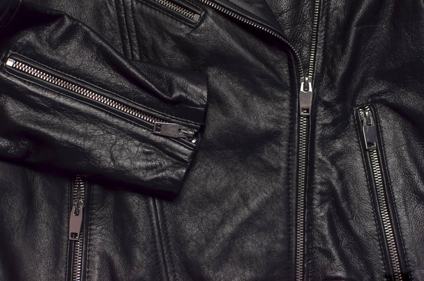 Close up details Black womens leather jacket top view. Fashionable modern trendy womens clothing. Vintage biker jacket. Black genuine leather texture - Zdjęcie, obraz