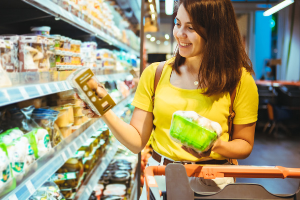 young pretty adult woman do shopping in grocery store lifestyle - Photo, Image